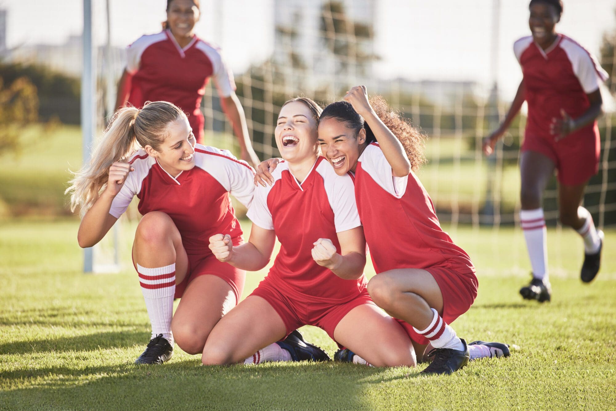 Unleash Team Spirit with Customized TShirts, Towels and More! 2 Celebrate, winning and success female football players with fist pump and hurray expression. Soccer team, girls or friends on a field cheering with victory sign, celebrating win in a sports match